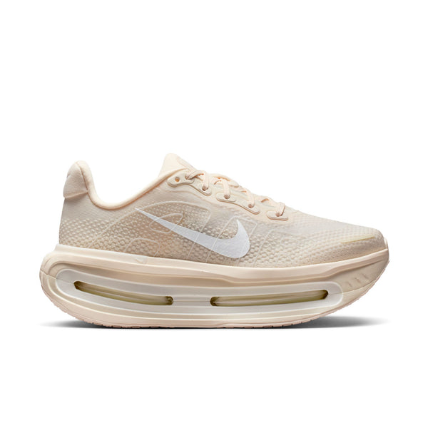 Beige Nike running shoe with Nike logo on a white background.