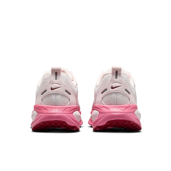 Pink and white sneakers with Nike logo on a white background