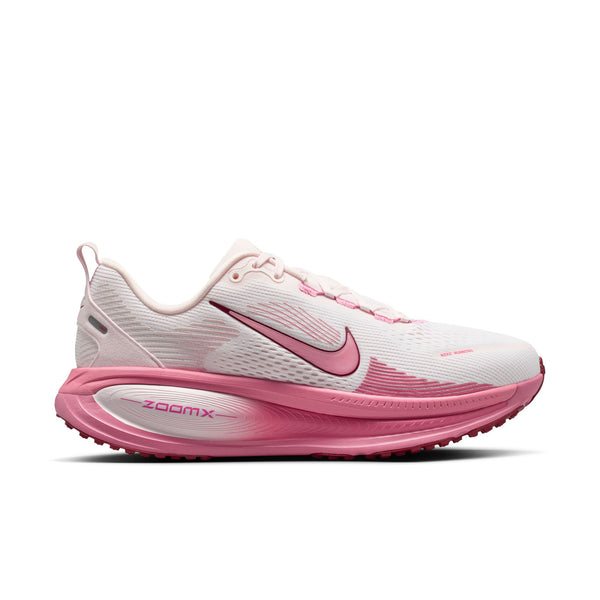 Pink and white running shoe with Nike logo on a white background.