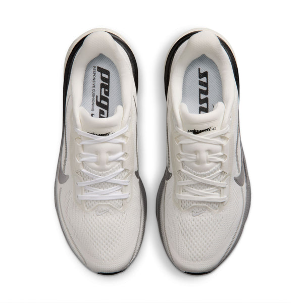 White running shoes with black soles on a white background