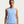 A woman wearing a light blue sleeveless athletic tank top with a small white Nike swoosh on the chest, photographed against a plain light gray studio background.