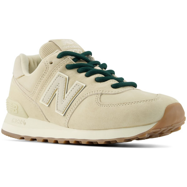 A New Balance sneaker in cream suede and leather with dark green laces, shown from on a white background.