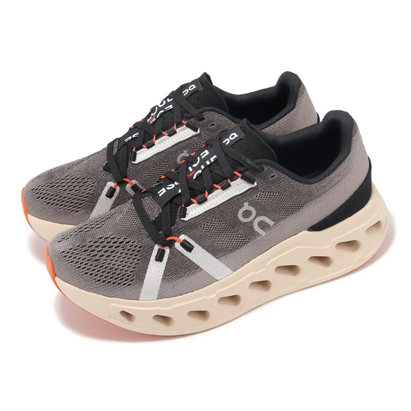 Pair of gray running shoes with black and orange accents on a white background.