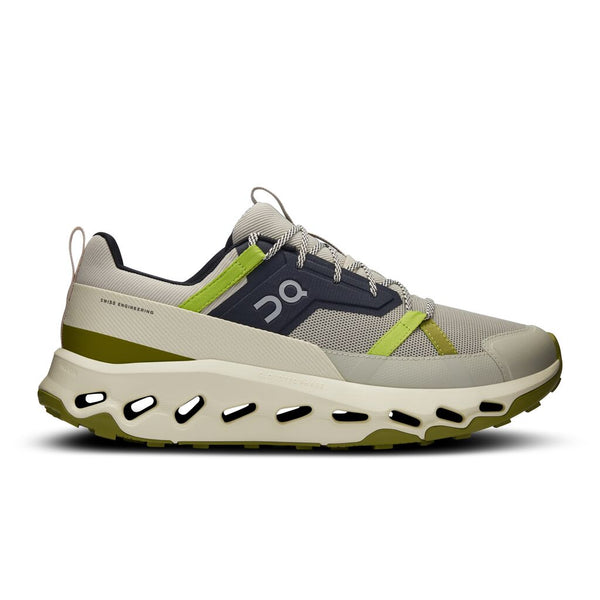 On gray and green sneaker with brand logo on a white background.