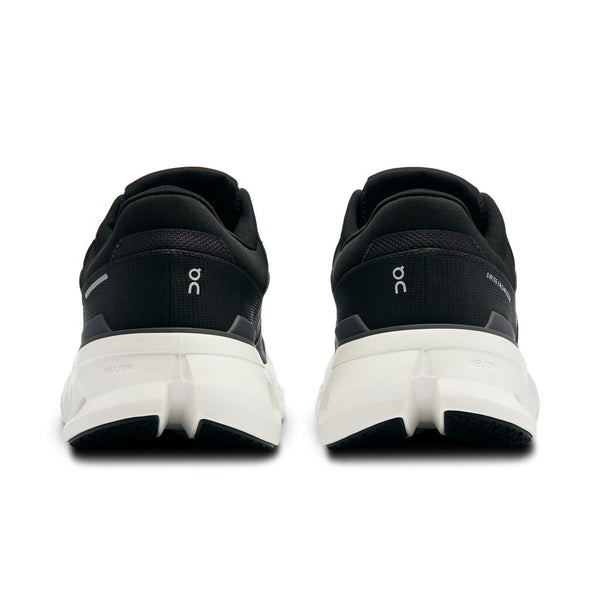 A pair of black and white running shoes with white soles on a white background.