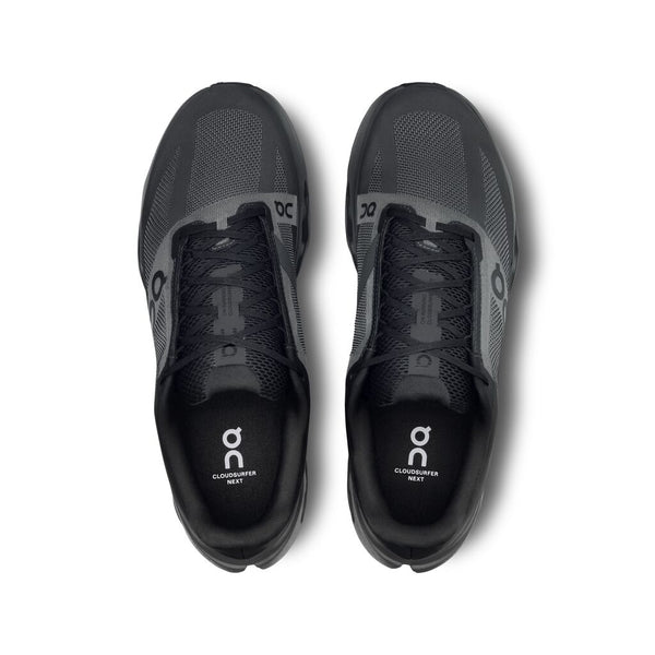 The top down view of a Men's On Cloud running shoe in all black from the floor to ceiling.