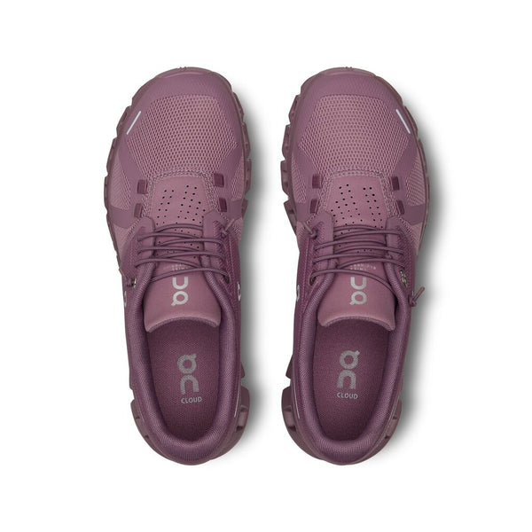 Pair of purple/fig running shoes on a white background.