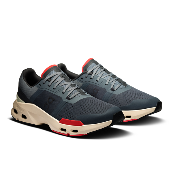 These gym shoes from On have a few red highlights near the outsole of the shoe.