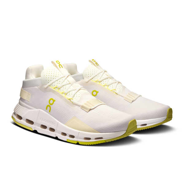 These On lifestyle shoes hae mostly all white with hits of pop yellow.