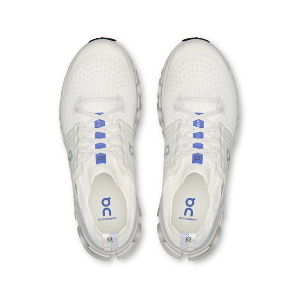 White sneakers with blue accents on a white background