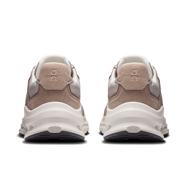 Pair of beige and white sneakers on a white background