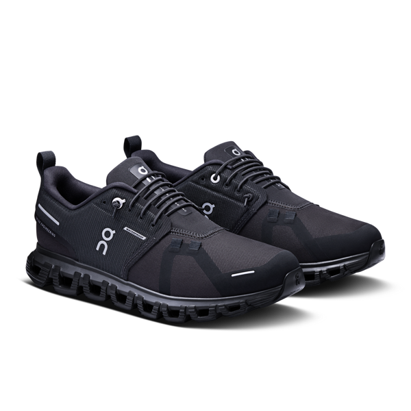 A pair of Women's On black athletic shoes on a white background that are waterproof.