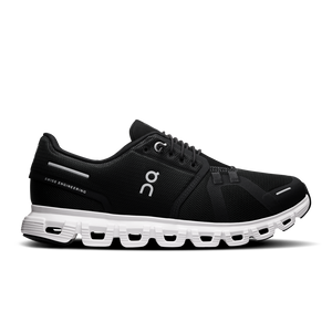 A pair of women's On athletic shoes with a black upper and a white sole.
