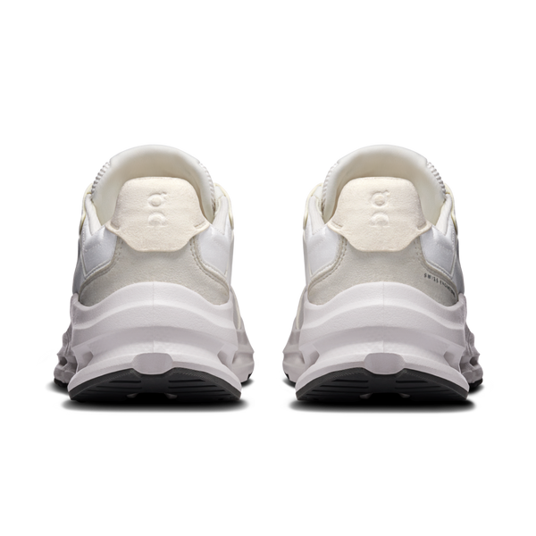 White athletic shoes with a black sole on a white background