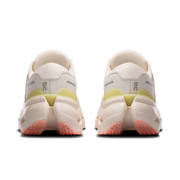 White running shoes with pink and green accents on a white background