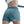 Person wearing teal athletic shorts on a white background