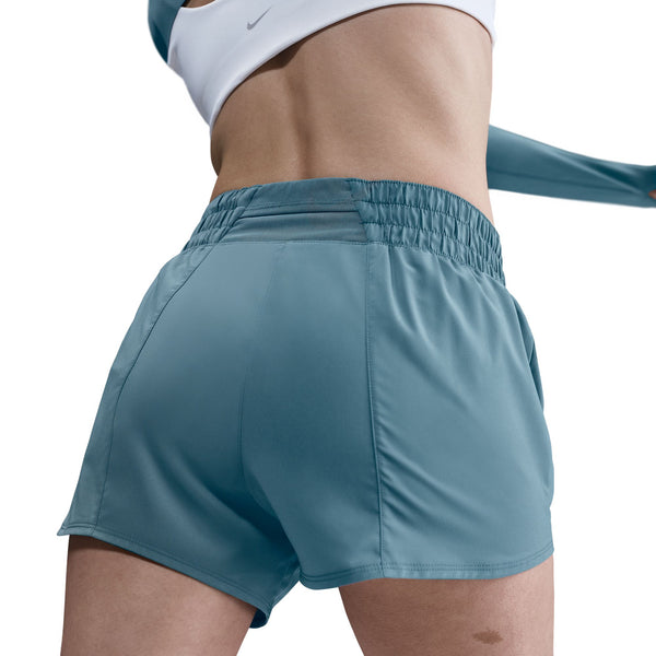 Person wearing teal athletic shorts on a white background