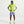 A man modeling a bright neon yellow-green Nike short-sleeve athletic shirt and light blue athletic shorts against a clean white studio background.