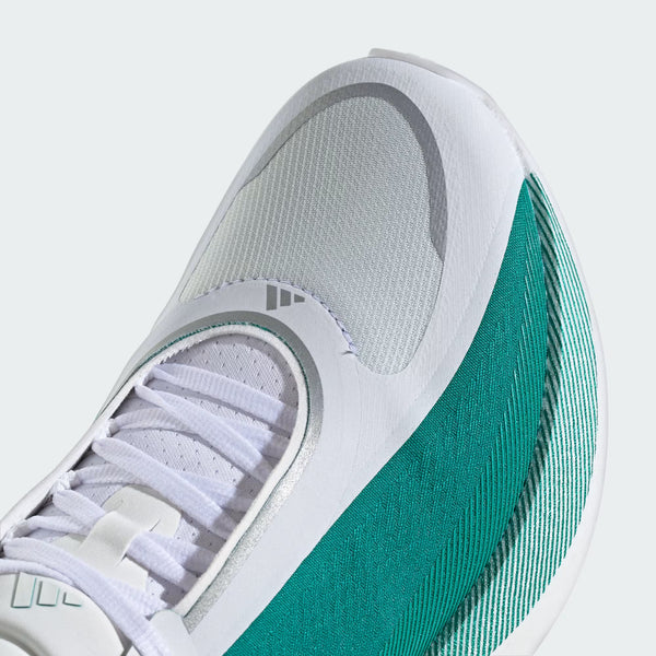 Close-up of a white and teal sneaker with Adidas logo on a light gray background