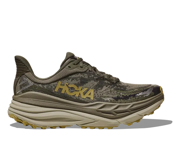 Camouflage running shoe with 'Hoka' branding on a white background