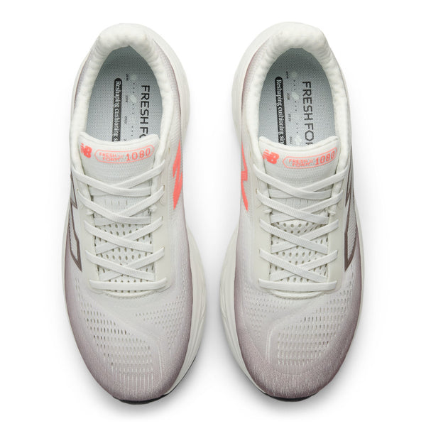 Pair of light gray sneakers with pink accents on a white background.