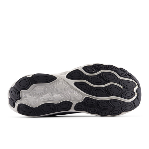 Close-up of a shoe sole with black and gray tread pattern on a white background