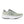 Green running shoe with white sole on a white background.