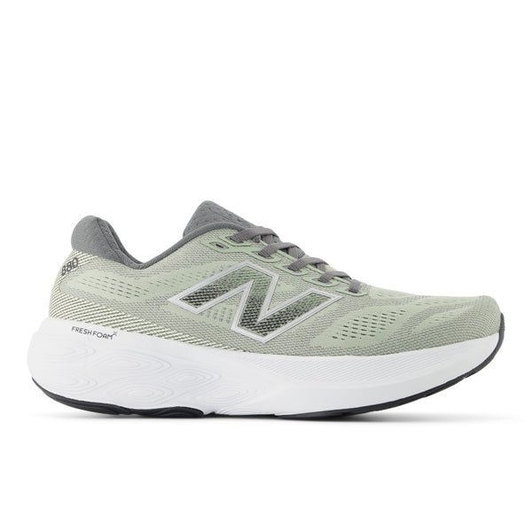 Green running shoe with white sole on a white background.