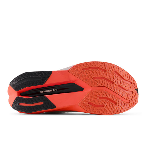 Close-up of a red and black athletic shoe sole on a white background.