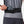 Person wearing a black waist pack with a phone in it, on a plain background