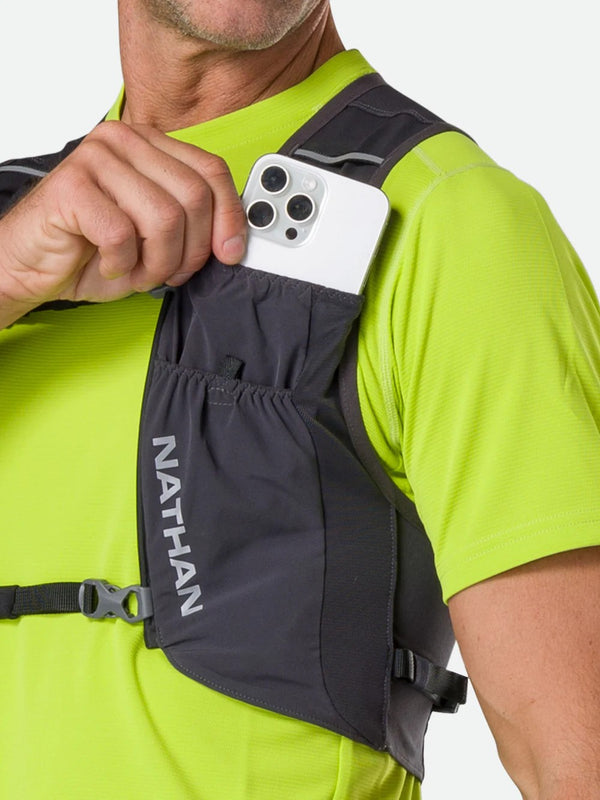 Person wearing a Nathan running vest with a phone case attached.