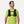 Man wearing a green shirt with a black hydration vest on a white background