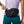 Person wearing a black waist bag with 'Nathan' branding, holding a phone.