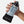 Hand holding a Nathan water bottle with a black sleeve against a white background