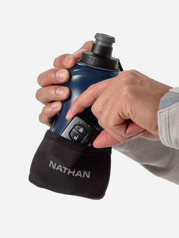Person holding a Nathan water bottle pouch on a white background