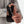Person holding a black and gray glove with a textured palm