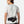 Person wearing a black waist bag with 'Nathan' branding on a white background