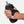 Hand holding a black wristlet with a gray water bottle inside on a white background