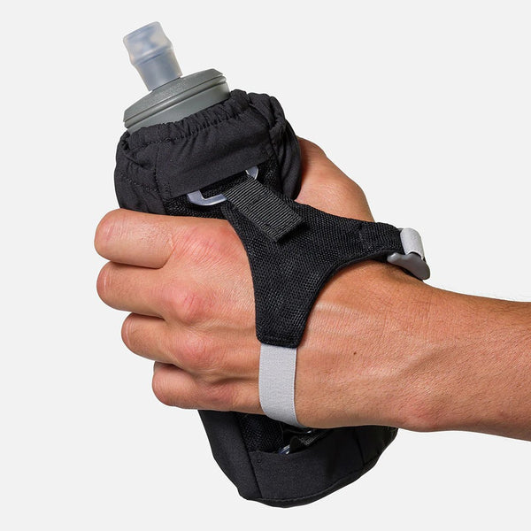 Hand holding a black wristlet with a gray water bottle inside on a white background
