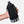 Black Nathan hydration bag held by a person against a white background