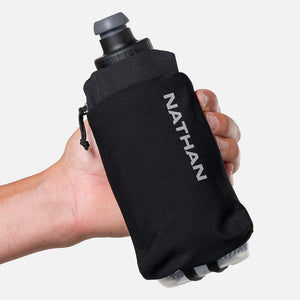 Black Nathan hydration bladder held in a hand against a white background