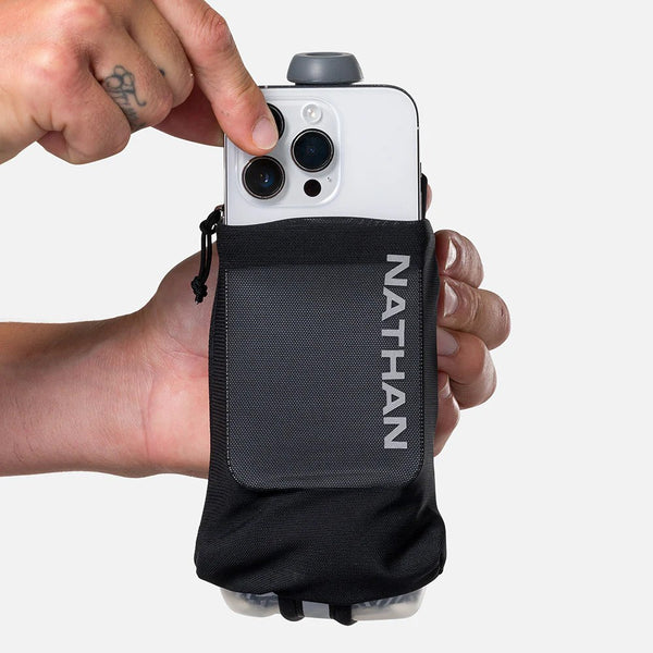Hand holding a phone with a black phone case labeled 'Nathan' against a white background