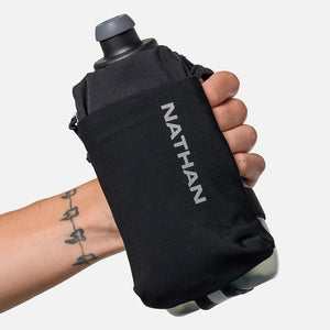 Black Nathan water bottle holder held by a person with a tattoo on a white background