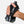 Hand holding a black wristlet with two water bottles against a white background