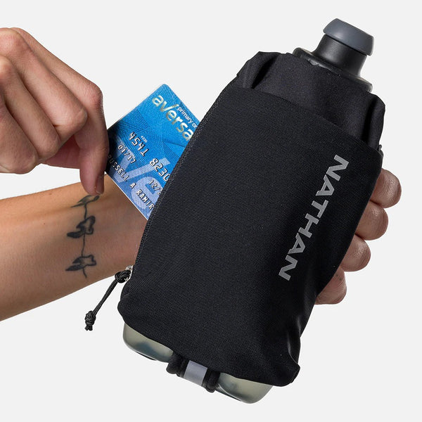 Black water bottle with a drawstring pouch, held by a hand, on a white background