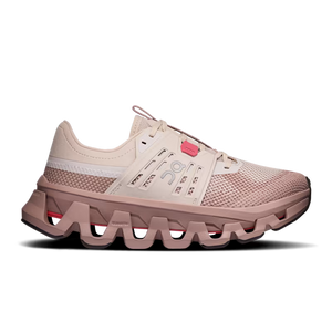 A single running shoe shown in profile against a solid white background. The shoe features a light beige mesh upper with a pinkish-beige chunky sole, a white stripe on the side, and a small pink accent near the laces.