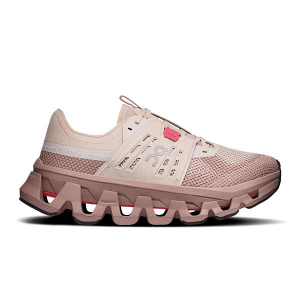 A single running shoe shown in profile against a solid white background. The shoe features a light beige mesh upper with a pinkish-beige chunky sole, a white stripe on the side, and a small pink accent near the laces.