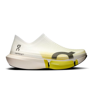 White running shoe with yellow accents on a white background