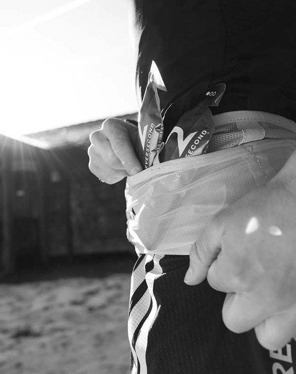 Person holding a sports bag with visible branding on a blurred background