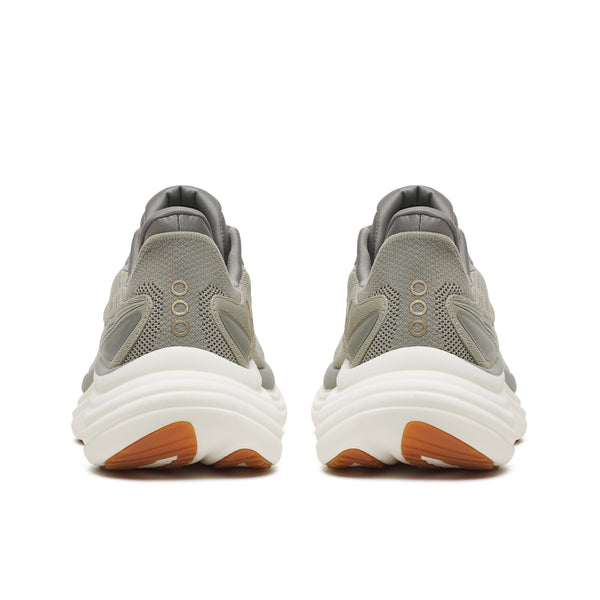 Gray running shoes with white soles and brown accents on a white background
